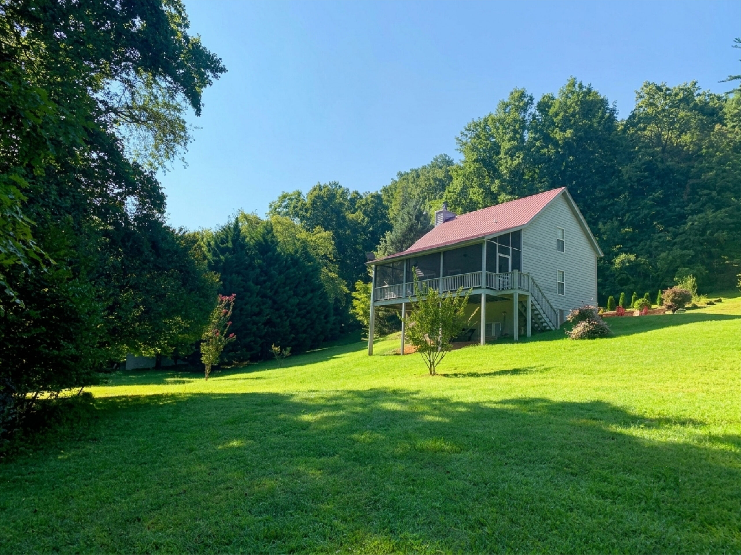 Cabin on a green hillside lawn at Highland Falls Cabins near Blairsville, GA
