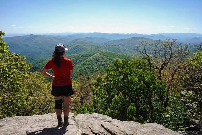 Hiker looking out over the Blue Ridge Mountains from a rocky overlook near Blairsville, GA