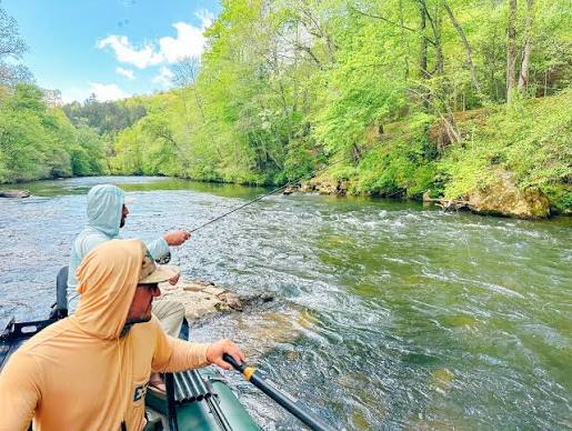 Two anglers fishing from a raft on a river near Blairsville, GA